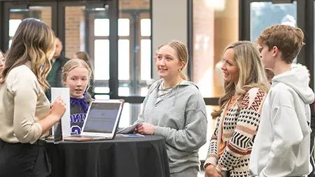 Family talking with admissions counselor.